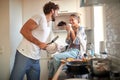 A young couple in love having good time while preparing a breakfast together. Cooking, together, kitchen, relationship Royalty Free Stock Photo