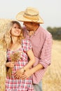 Young couple in love on haystacks in cowboy hats Royalty Free Stock Photo