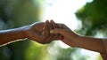 Young couple in love holding hands against park background, trustful relations Royalty Free Stock Photo