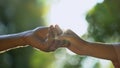 Young couple in love holding hands against park background, trustful relations