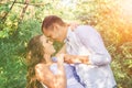 Young couple in love holding hands, hugging and smiling in trees tunnel. Men tilted the woman. Outside portrait of young couple Royalty Free Stock Photo