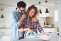 Young couple at home doing hosehold chores and ironing