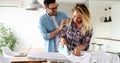 Young couple at home doing hosehold chores and ironing Royalty Free Stock Photo