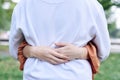 Young couple in love hugging each other in the park. Close up picture of girlfriend embracing her boyfriend, standing with his Royalty Free Stock Photo