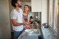 A young couple in love joking while preparing a breakfast together. Relationship, together, kitchen, love Royalty Free Stock Photo