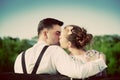 Young couple in love kissing on a bench in park. Vintage. Royalty Free Stock Photo