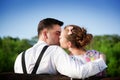 Young couple in love kissing on a bench in summer park Royalty Free Stock Photo