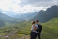 Young couple in love kissing each other. Wonderful panorama of the swiss alps in the background