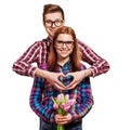 Young couple in love make a heart and hands are holding tulips. Royalty Free Stock Photo