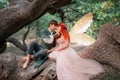 Young couple in love. A man and a woman are hugging on a huge tree. Themed creative wedding bright fantasy photography Royalty Free Stock Photo
