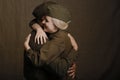 Young couple in love in military uniform from second world war hugs from joyous long awaited meeting