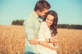 Young couple in love outdoor.Couple hugging.Young beautiful couple in love staying and kissing on the field on sunset. Royalty Free Stock Photo