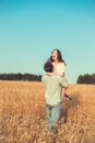 Young couple in love outdoor.Couple hugging.Young beautiful couple in love staying and kissing on the field on sunset. Royalty Free Stock Photo