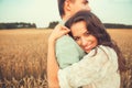 Young couple in love outdoor.Couple hugging.Young beautiful couple in love staying and kissing on the field on sunset. Royalty Free Stock Photo