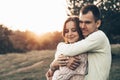 Young couple in love outdoor. They are smiling and looking at each other. evening sunlight, hugs and kisses, vintage style Royalty Free Stock Photo