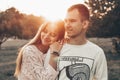 Young couple in love outdoor. They are smiling and looking at each other. evening sunlight, hugs and kisses, vintage style Royalty Free Stock Photo