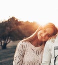 Young couple in love outdoor. They are smiling and looking at each other. evening sunlight, hugs and kisses, vintage style Royalty Free Stock Photo