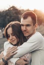 Young couple in love outdoor. They are smiling and looking at each other. evening sunlight, hugs and kisses, vintage style Royalty Free Stock Photo