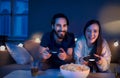 Young couple in love playing video games indoors at home. Royalty Free Stock Photo