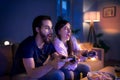 Young couple in love playing video games indoors at home. Royalty Free Stock Photo