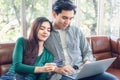 Young Couple Love Relax Enjoyment While Online Shopping on Electronic Laptop in Living Room, Portrait of Asian Couple Relaxing on Royalty Free Stock Photo