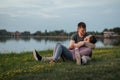 Young couple in love resting at the beach, the woman lays in the man`s arms. Royalty Free Stock Photo