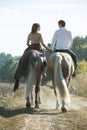 Young couple in love riding a horse