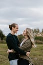 Young Couple in Love Running in a Big Open Outdoor Field in the Spring Holding Hands and Laughing Royalty Free Stock Photo