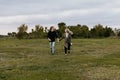 Young Couple in Love Running in a Big Open Outdoor Field in the Spring Holding Hands and Laughing Royalty Free Stock Photo