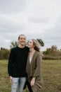 Young Couple in Love Running in a Big Open Outdoor Field in the Spring Holding Hands and Laughing Royalty Free Stock Photo