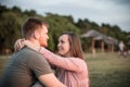 Young couple in love sitting by the beach, staring into each others eyes Royalty Free Stock Photo