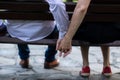 Young couple in love sitting on a bench, holding hands