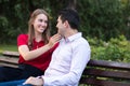 Young couple in love sitting on a bench in the park