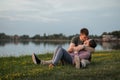 Young couple in love sitting together on the beach Royalty Free Stock Photo