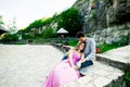 Young couple in love sitting together on a bench in summer park. Happy future, marriage concepts. Vintage Royalty Free Stock Photo