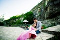 Young couple in love sitting together on a bench in summer park. Happy future, marriage concepts. Vintage Royalty Free Stock Photo