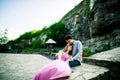 Young couple in love sitting together on a bench in summer park. Happy future, marriage concepts. Vintage Royalty Free Stock Photo