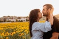 Young couple in love in the sunflower field at sunset Royalty Free Stock Photo