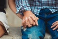 Couple in love touched hands on the first date. Man in denims.