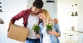 Young couple unpacking cardboard boxes at new home moving in concept Royalty Free Stock Photo