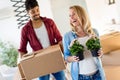 Young couple unpacking cardboard boxes at new home moving in concept Royalty Free Stock Photo