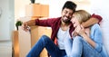 Young couple unpacking cardboard boxes at new home moving in concept Royalty Free Stock Photo