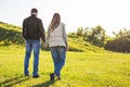 Young couple in love walking in the autumn park holding hands looking in the sunset. Royalty Free Stock Photo