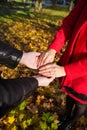 Young couple in love walking in the autumn park holding hands looking in the sunset Royalty Free Stock Photo