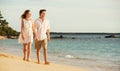 Young couple in love walking on the beach at sunset Royalty Free Stock Photo