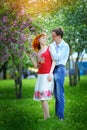 Young couple in love walking at the blossoming spring garden Royalty Free Stock Photo