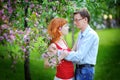 Young couple in love walking at the blossoming spring garden Royalty Free Stock Photo