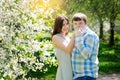 Young couple in love walking in the blossoming spring garden Royalty Free Stock Photo