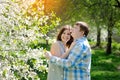Young couple in love walking in the blossoming spring garden Royalty Free Stock Photo