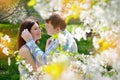 Young couple in love walking in the blossoming spring garden Royalty Free Stock Photo